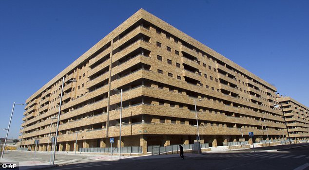 Alone: A single jogger runs past empty apartment blocks in Sesena, where 30,000 people were due to live